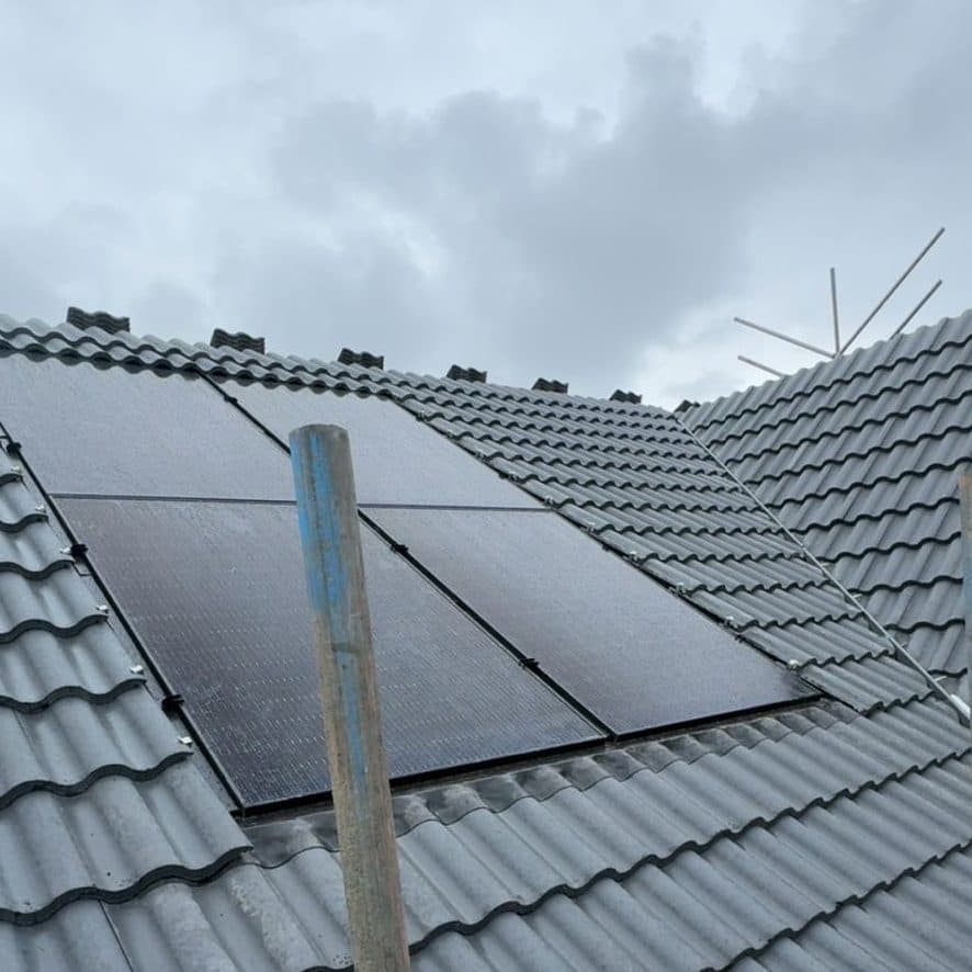 A tiled roof finished neatly around a set of solar panels