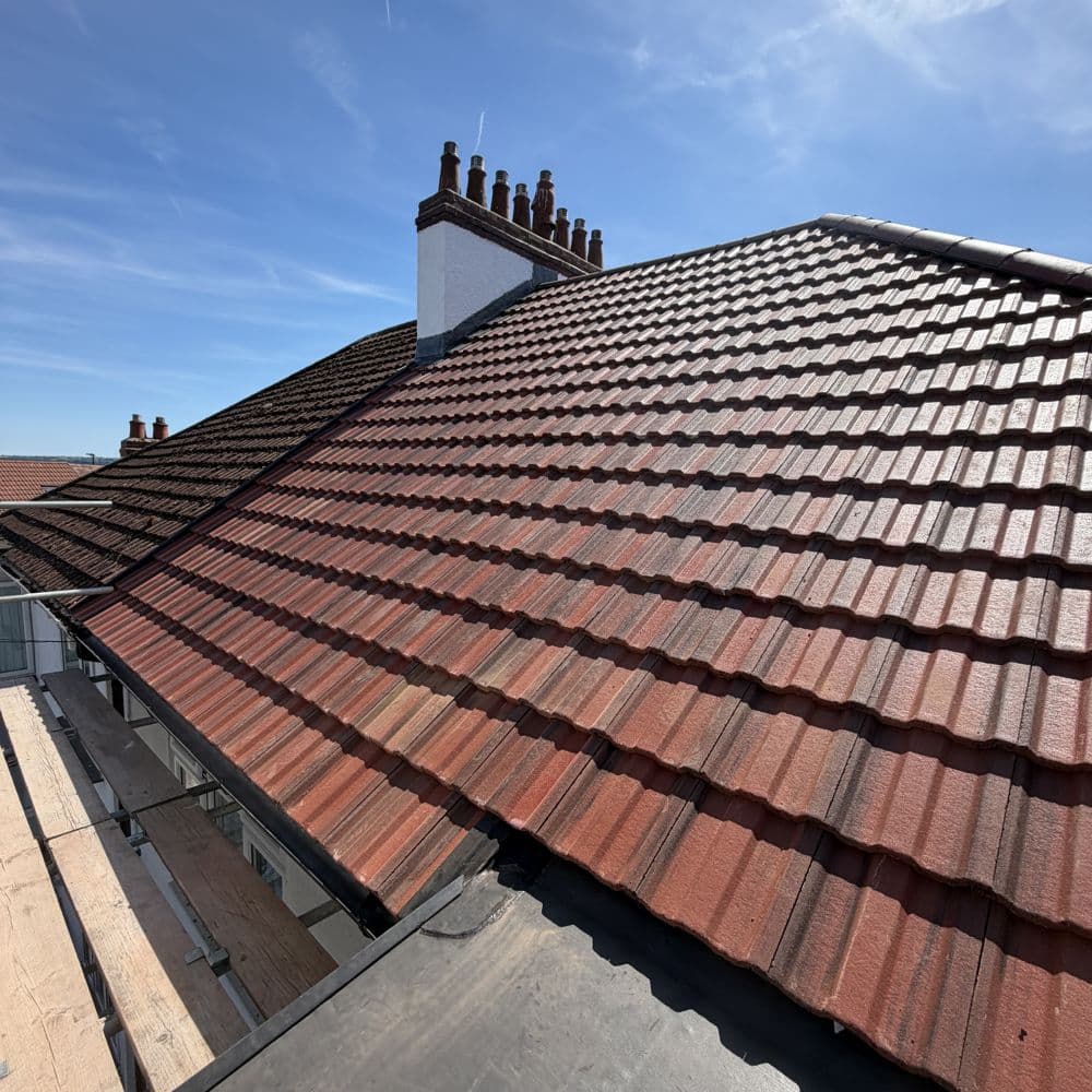 A completed re-roof with a new dry ridge system and repointed chimney