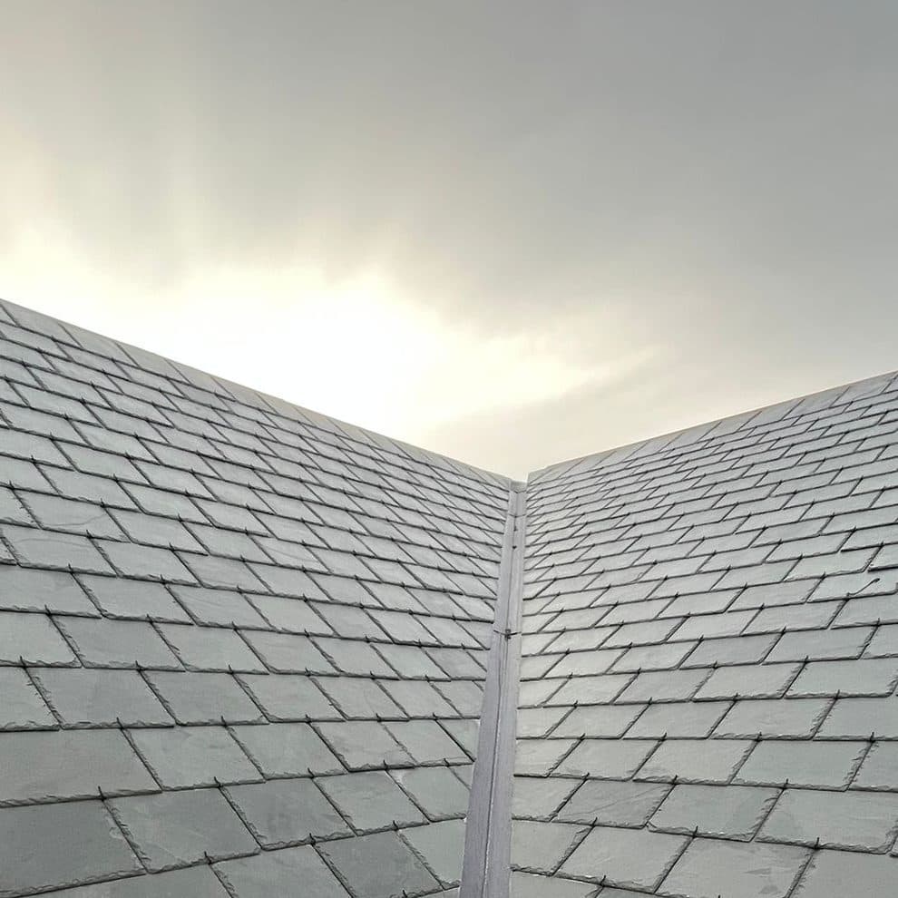 A new lead valley running between two slate roof slopes