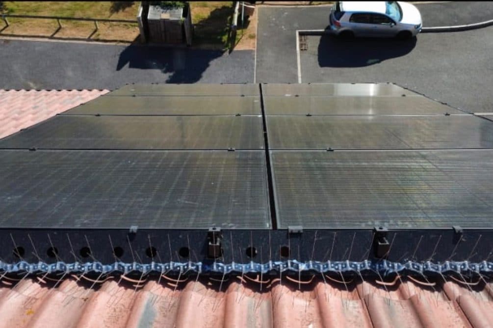Bird proofing fitted along the bottom edge of a set of roof-mounted solar panels