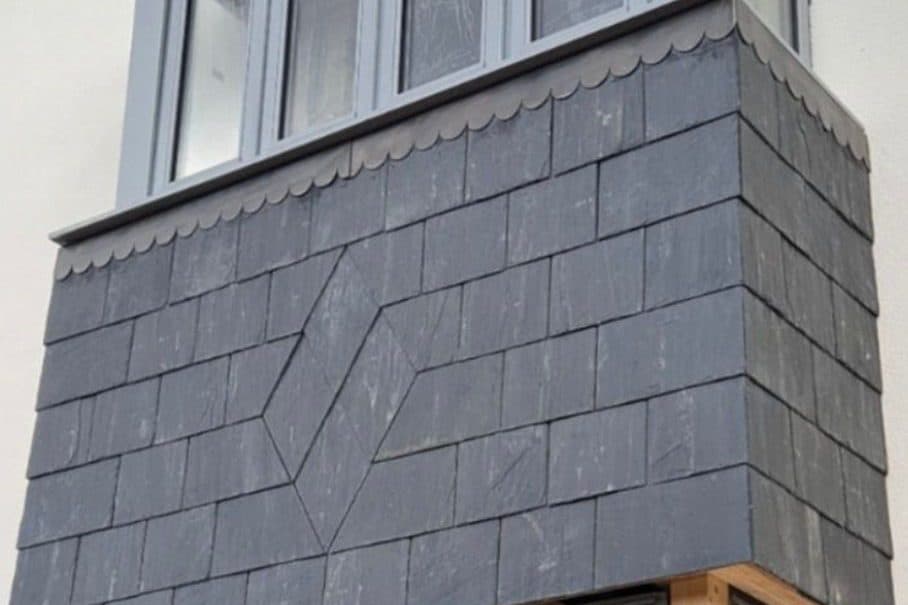 A slate-hung bay window with a diamond detail set into the slate