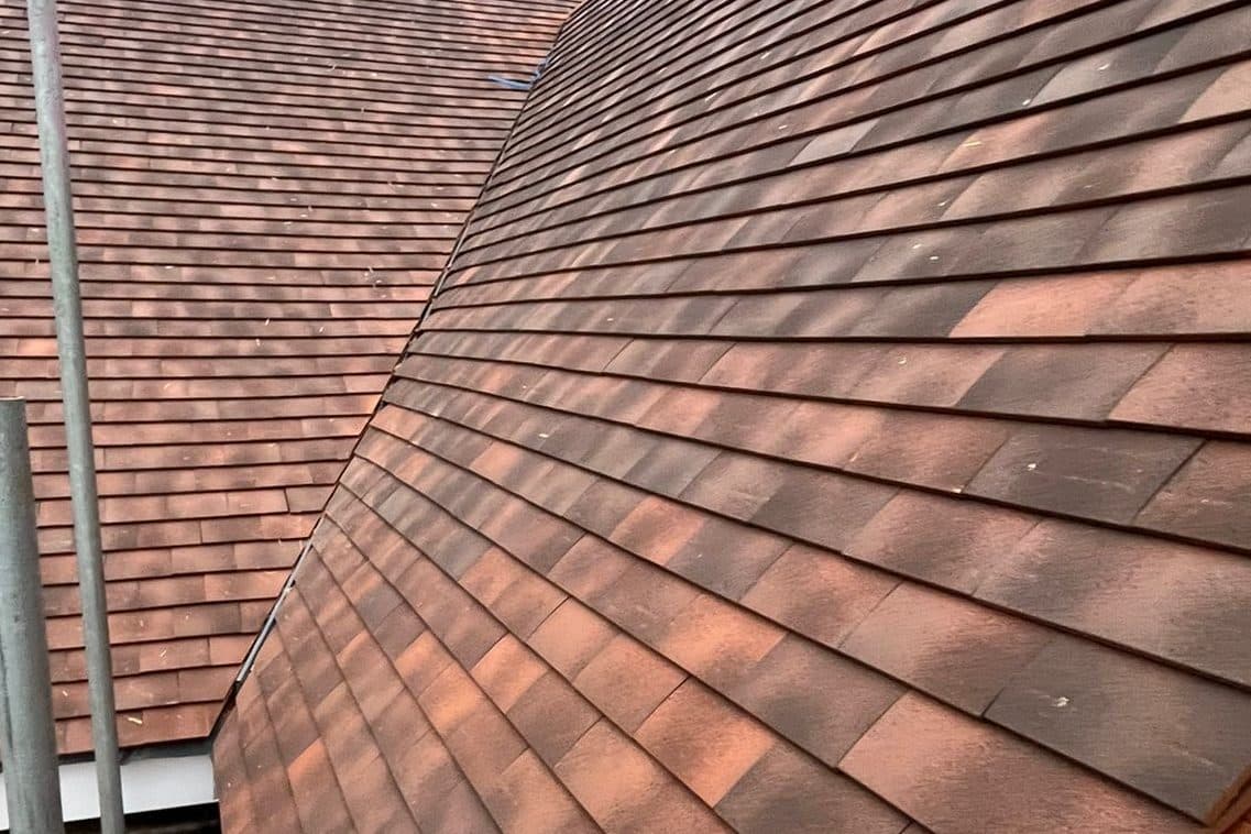 A finished clay tile hip after repair work